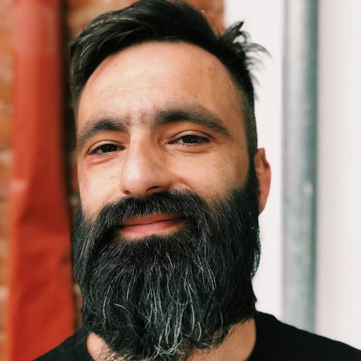 Aarya Sen, Lead Design Curator at Forest Meadow Bay, reviewing corporate floral arrangements